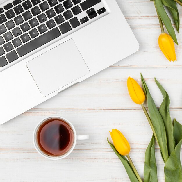 Free photo composition of yellow tulips on work desk