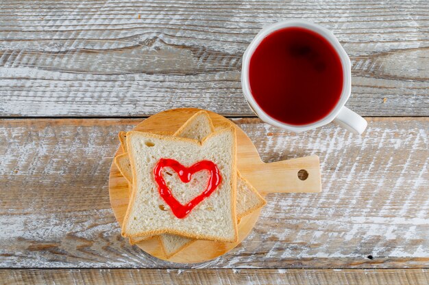 Compote in a cup with jam on toast bread flat lay on wooden and cutting board