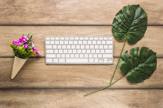 Tastiera del computer con foglie e fiori