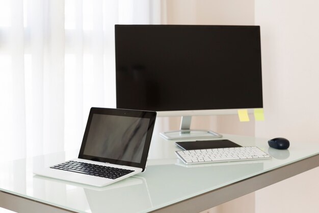 Computer and laptop on desk
