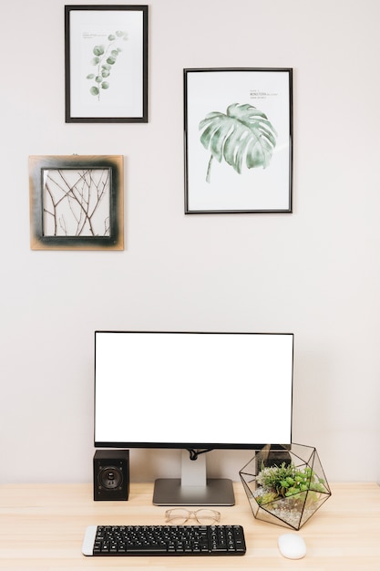 Computer monitor with keyboard on table