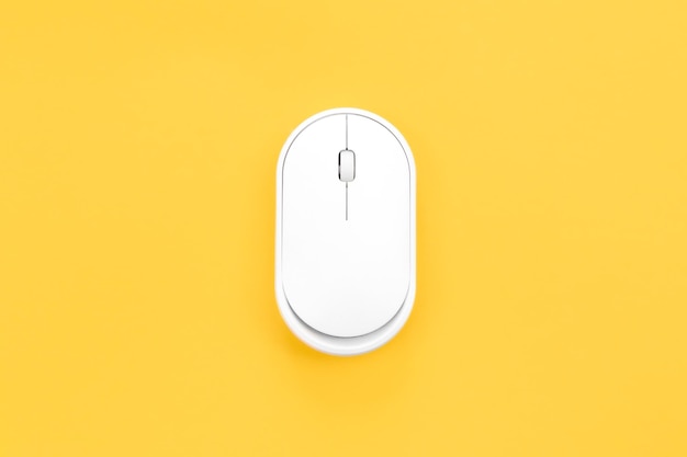 Computer mouse on a yellow background isolated flat lay