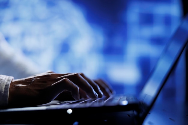 Computer operator using laptop to maintenance artificial intelligence neural networks simulating human thought processes in computerized model. Tech support doing checkup on AI systems, close up