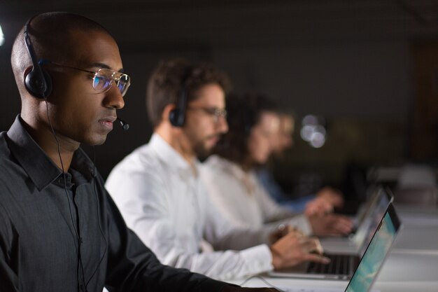 Concentrated African American call center operator working