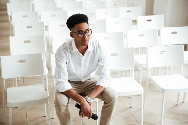 Concentrated african man sitting in office indoors
