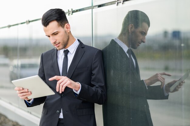 Concentrated analyst reviewing a document on your tablet