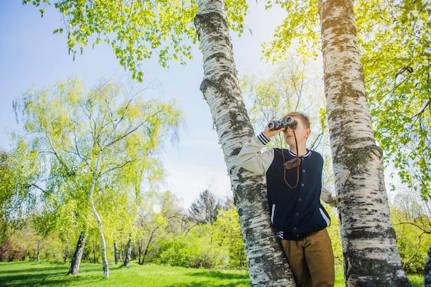 Concentrated boy with binoculars