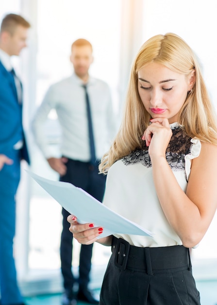 Free photo concentrated businesswoman examining documents