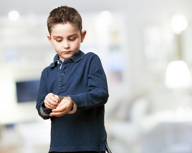 Concentrated child playing with handcuffs