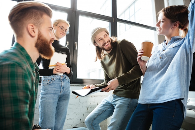 Concentrated colleagues in office talking with each other