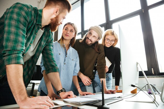 Concentrated colleagues standing in office