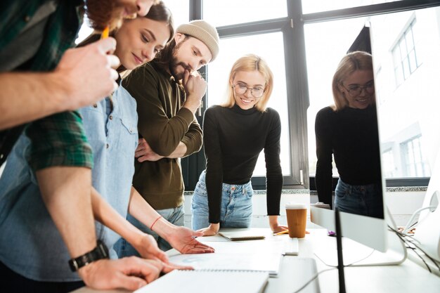 Concentrated colleagues standing in office