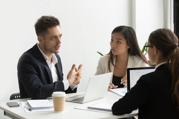 concentrated coworkers discussing company business strategies