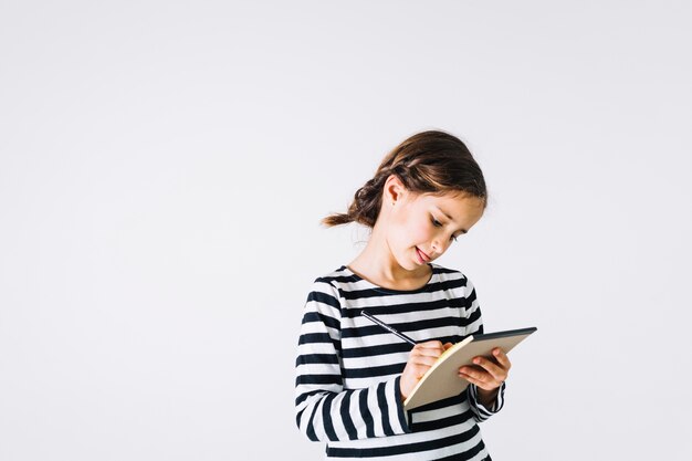 Concentrated girl making notes