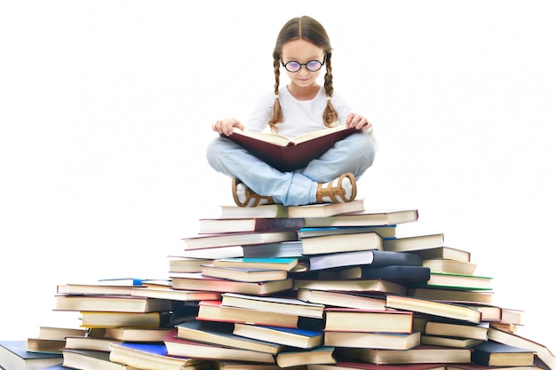 Free photo concentrated girl surrounded by books