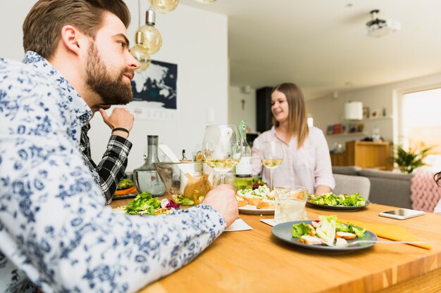 Concentrated handsome man sitting at table