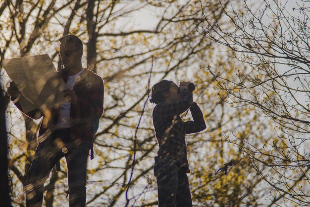 Concentrated hikers with map and binoculars