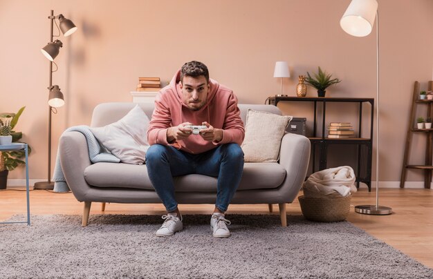 Concentrated man on couch playing