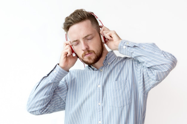 Concentrated man listening to music in headphones