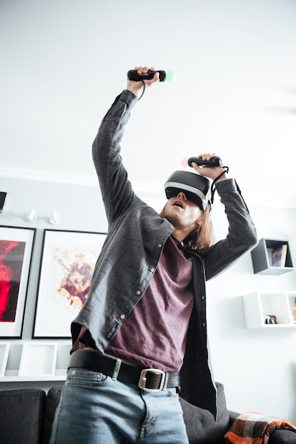 Concentrated man sitting at home indoors play games