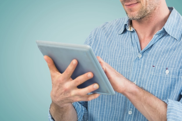 Concentrated man using his tablet