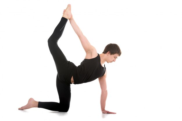 Concentrated man in a yoga posture