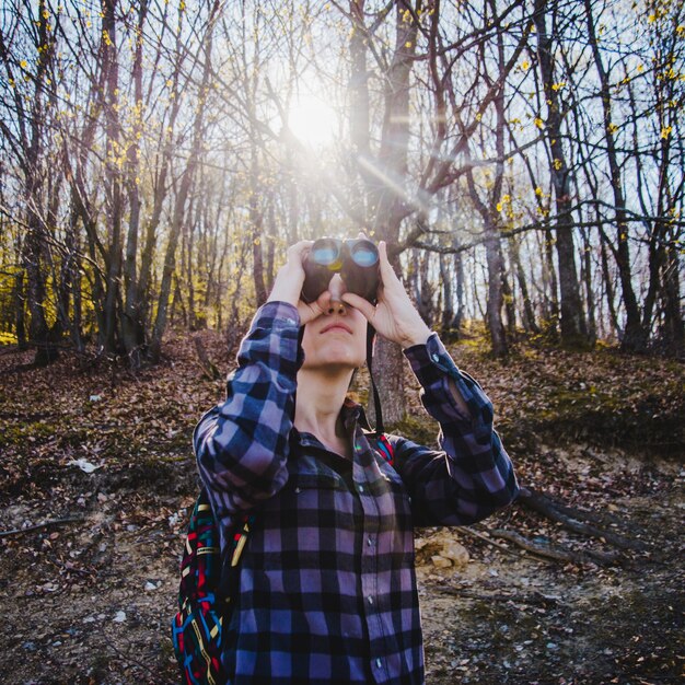 Concentrated rambler using her binoculars