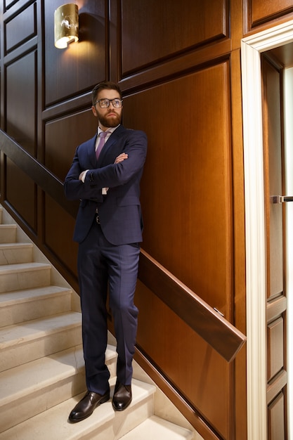 Concentrated serious bearded young businessman