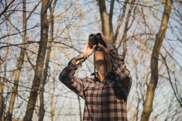 Concentrated traveler using binoculars