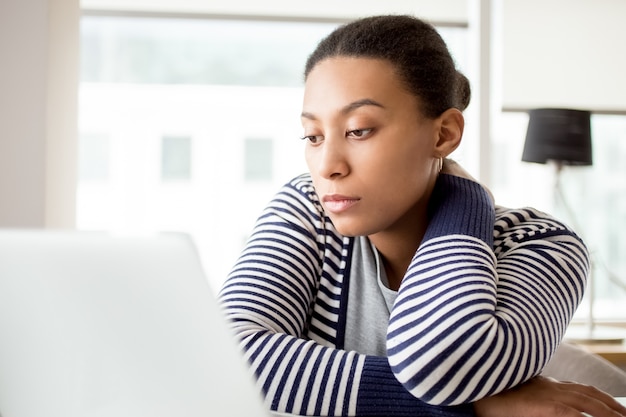 Concentrated woman reading business article