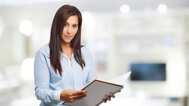 Free photo concentrated woman reading an open notebook