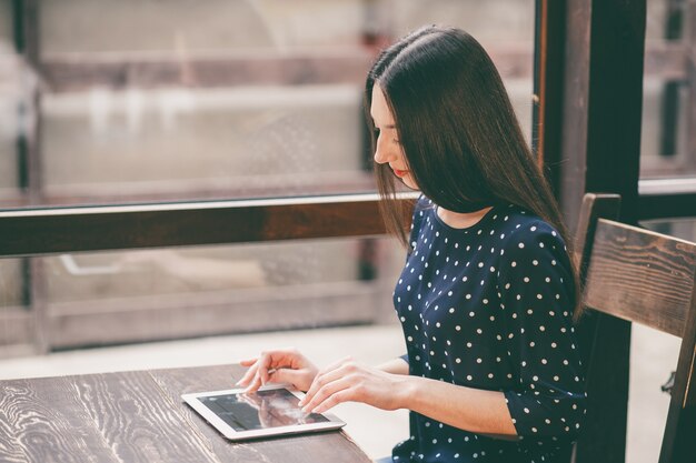 Concentrated woman studying with tablet