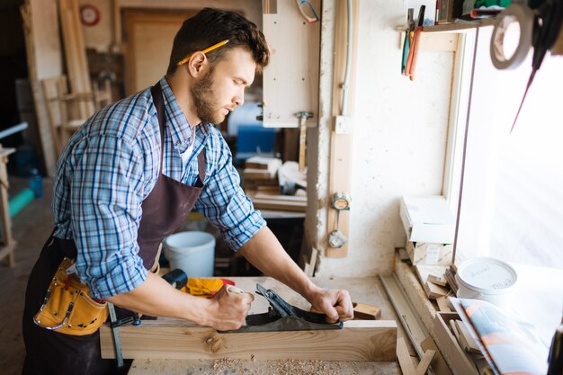 Concentrated woodworker in workshop