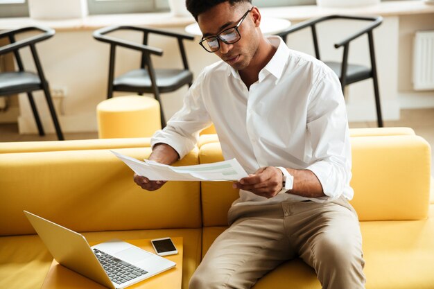 Concentrated young african man sitting coworking