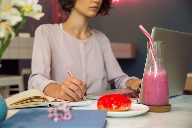 Concentrated young girl writing notes