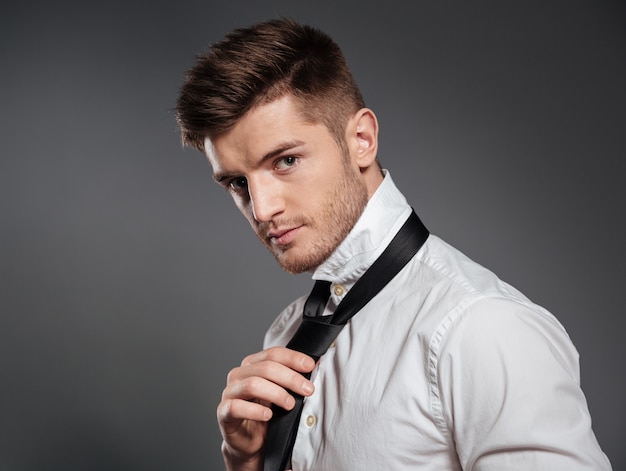 Free Photo | Concentrated young man dressed in formalwear