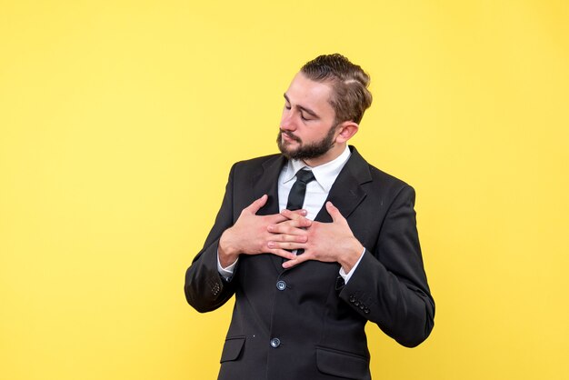 Concentrated young man in suit closing eyes