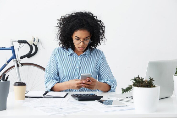 Free Photo concentrated young mixed race female secretary reading urgent message