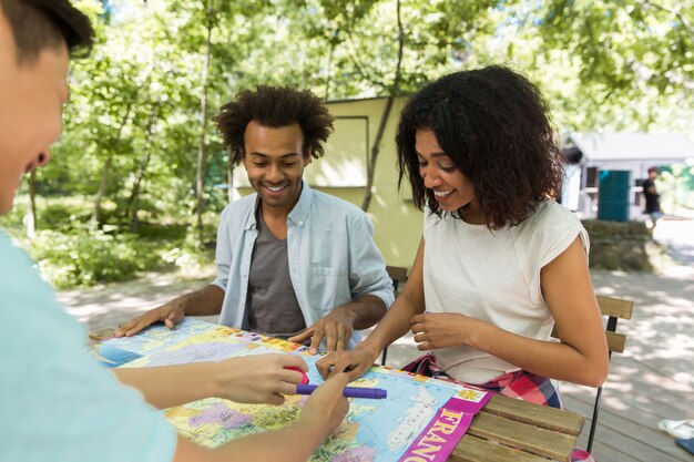 Concentrated young multiethnic friends students outdoors studying