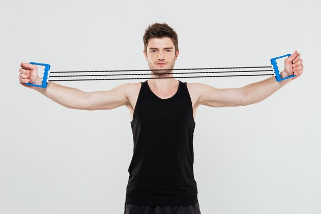 Concentrated young sportsman make sport exercises