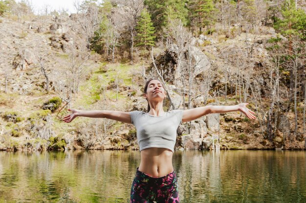 Concentrated young woman with open arms