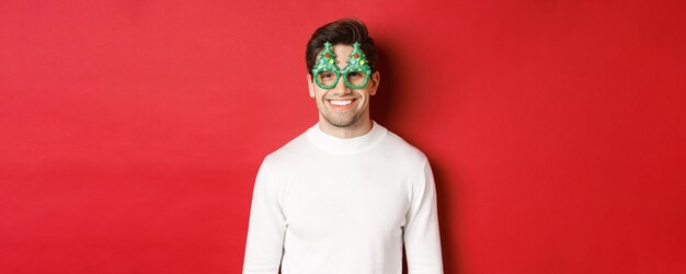Concept of christmas winter holidays and celebration closeup of handsome man in white sweater and pa...