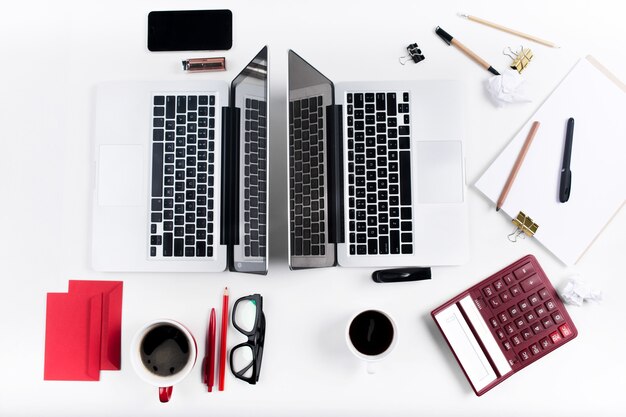 Concept of comfortable male and female workplaces. Gadgets on the white desk