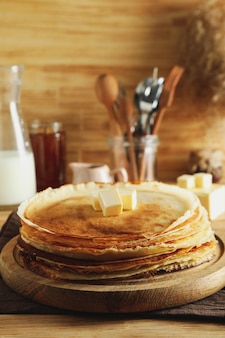 Concept of cooking with crepes on wooden table