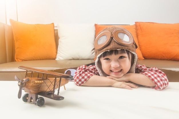 The concept of dreams and travel.the child plays the role of a pilot and dreams of flying into space.