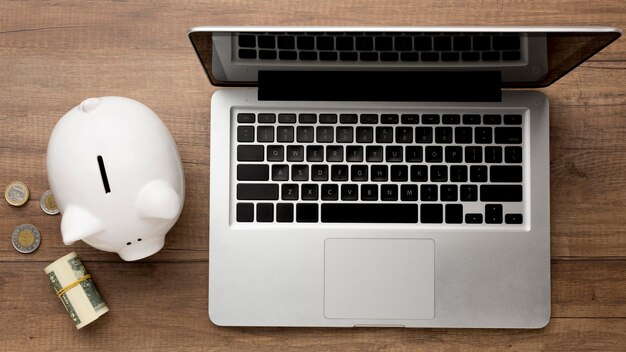 Concept of economy with piggy bank and laptop