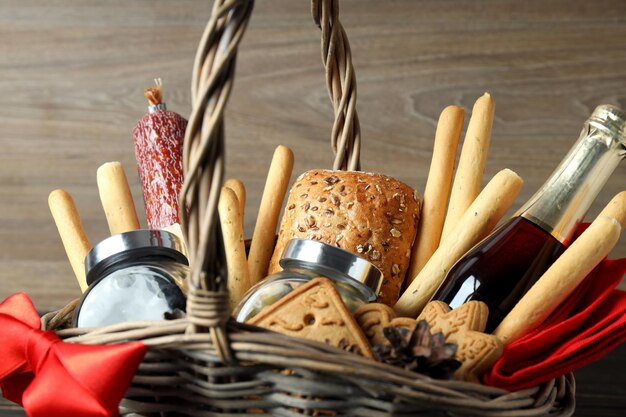 Concept of gift with christmas basket on wooden background