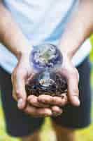 Free photo concept hands holding earth in bulb