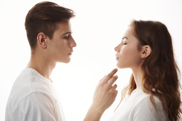 Concept of love tenderness and romance. Young romantic couple standing in front of each other.