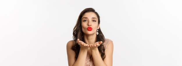 Concept of new year celebration and winter holidays closeup of sensual young woman in dress pucker l